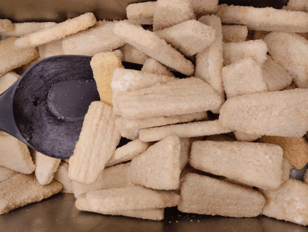 Close up of a pile of crackers with a black spoon.の写真素材