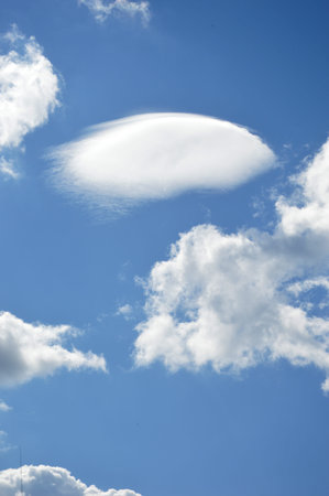 White clouds in the blue sky used as background.