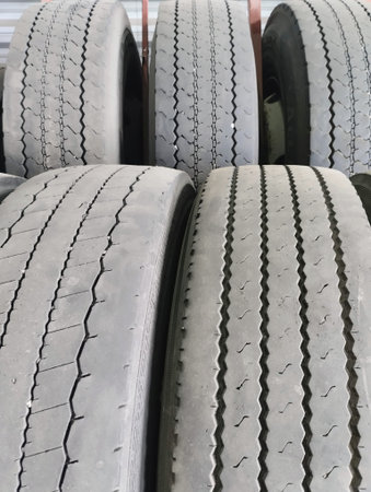 Car tires stacked in a row, close-up of photo.
