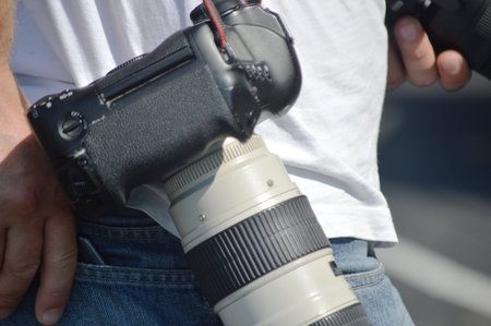 Photographer with DSLR camera in hand. close-up.の写真素材