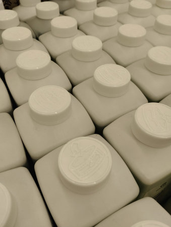 bottles of milk in a dairy farm, closeup of photo