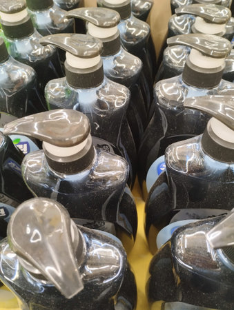 Group of plastic bottles for liquid laundry detergent in a supermarket.の写真素材