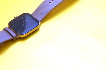 Smart watch on a yellow background with space for text, close up