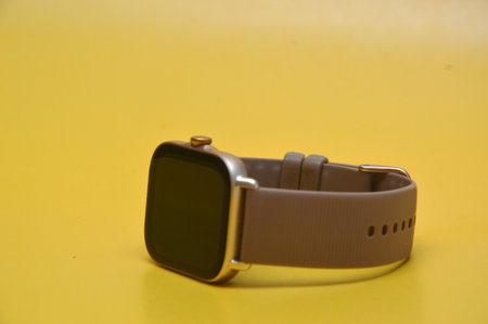 Smart watch isolated on a yellow background, closeup of photo.の写真素材
