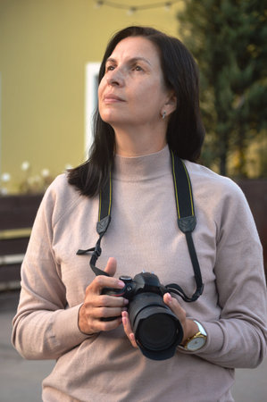 Portrait of a middle-aged woman with a camera in her hands