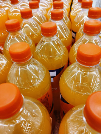 Plastic bottles of orange juice in a supermarket. Close-up.の写真素材