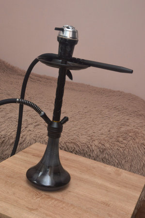 Hookah on a wooden table in the interior of a room