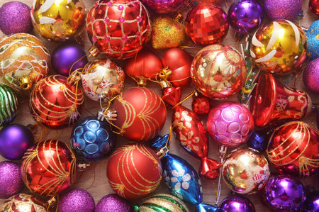 Colorful christmas ornaments on wooden background. Top view.