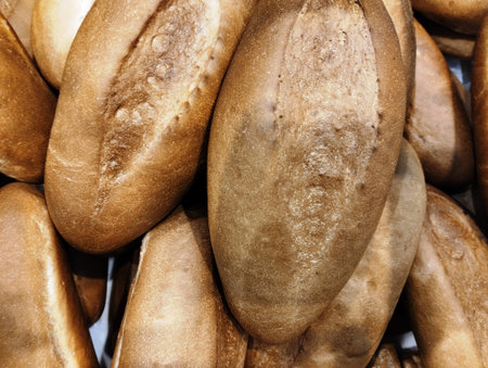 Pile of freshly baked bread. Close-up. Whole background.