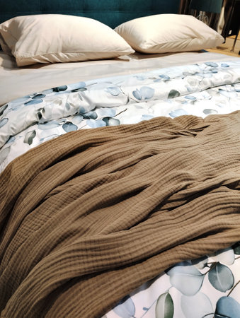 close up of bedding in a modern bedroom with blue and brown tonesの写真素材