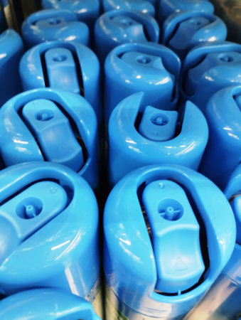 Blue plastic beer cans in a row at a brewery, closeup of photoの写真素材