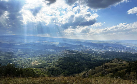 View from the top of the mountain in the rays of the sun