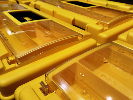 Yellow plastic trash cans in a row. Close-up. Selective focus.