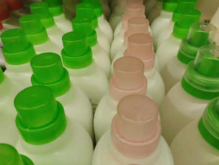 Plastic bottles with detergent on shelf in warehouse, closeup of photo