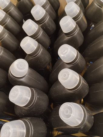 A closeup shot of a group of black plastic bottles with capsの写真素材