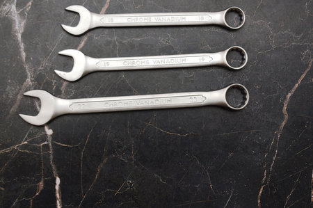 Set of spanners on a black marble background, top view.の写真素材