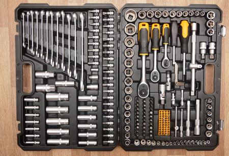 A set of tools for repair and installation on a wooden background.