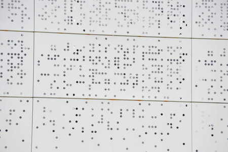 Close up of the wall of a modern office building with many holesの写真素材