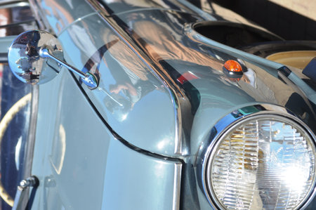 Close-up of the headlight of an old classic car.