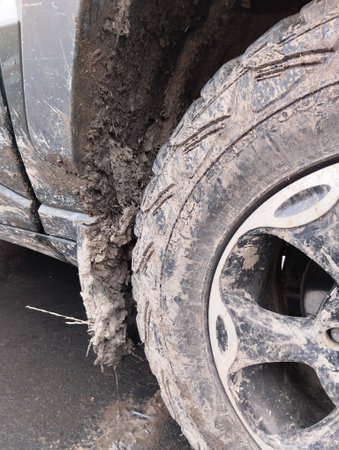 Close-up of the wheel of a car stuck in the mud
