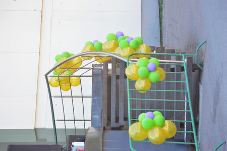 Colorful balloons in a shopping cart on the stairs, stock photoの写真素材
