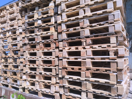 Wooden pallets stacked in the warehouse, closeup of photo