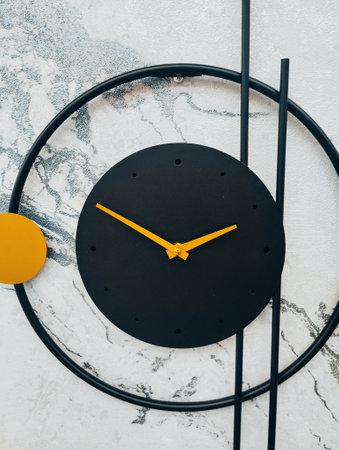 Black wall clock with yellow circlele background. Minimal styleの写真素材
