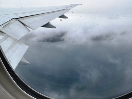 Clouds and sky as seen through window of an aircraft. Travel conceptの写真素材