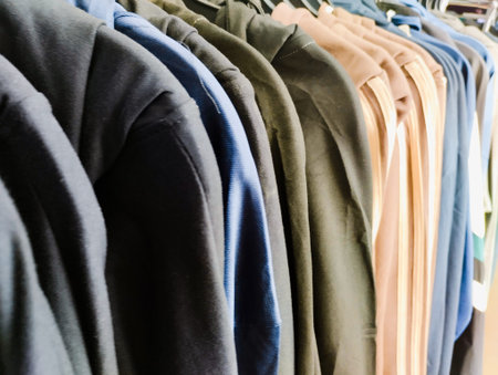 clothing on hangers in a fashion store or clothing store for sale