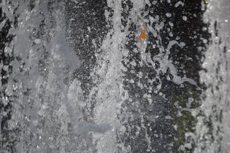 Water splashes on a black background close-up macro photo.