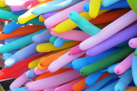 colorful balloons on sale in a market, closeup of photoの写真素材