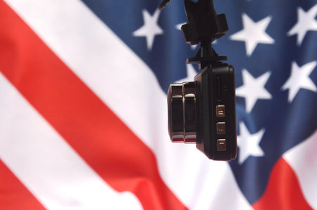 USA flag and a device on the background. Selective focus.の写真素材