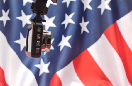 Close-up of a camera on the background of the American flagの写真素材