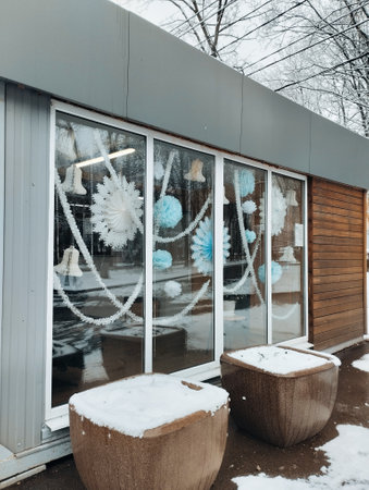 Snow-covered wooden windows in the yard of the house.の写真素材