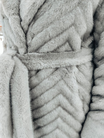 beautiful fur coat of beige color, closeup of photo