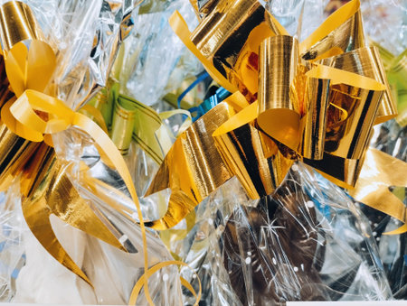 Close-up of a lot of golden and silver ribbons on a white background.