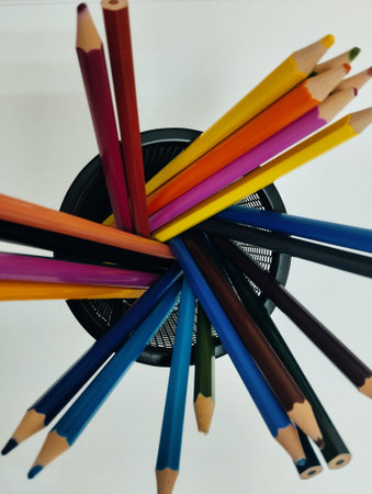 colored pencils in a container on a white background close-up