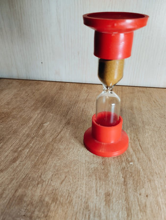 Old hourglass on wooden table. Time concept.