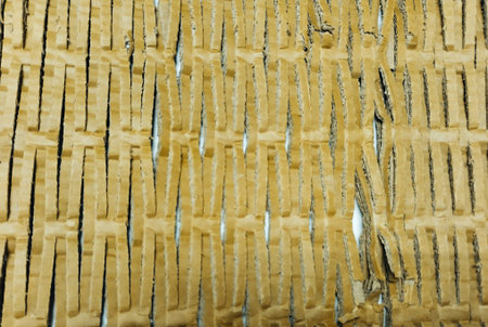 Corrugated cardboard texture useful as a background - yellow toned