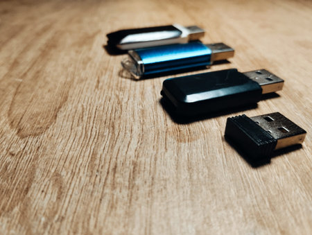 Usb flash drive on a wooden background. Selective focus.