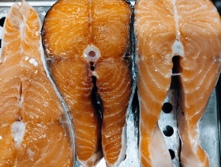 Fresh salmon fillet on ice. Shallow depth of field. Toned.の写真素材