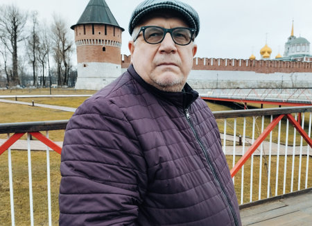 Portrait of a middle-aged man in a hat on a background of the Kremlin.