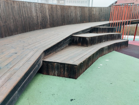 Wooden stairs with green background.