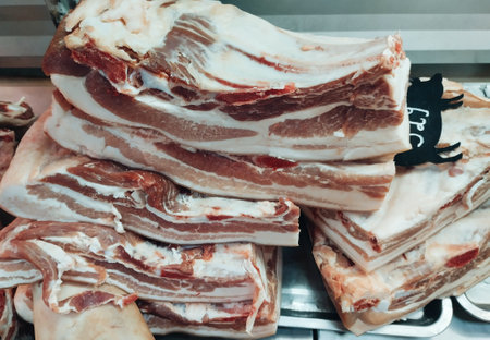 Slices of bacon on a shelf in a butcher shop.の写真素材