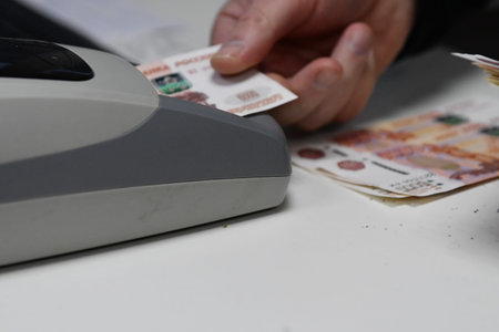 Credit card reader and cash register with Russian banknotes on the table