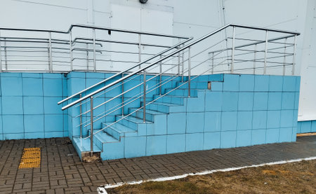 Staircase in a building with blue walls and metal railingsの写真素材