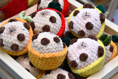 Handmade crochet panda bears in a wooden box.の写真素材