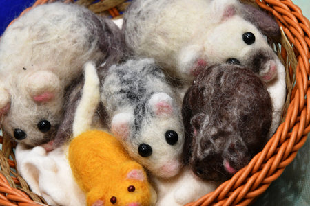 Close up of handmade woolen toy mouse in a wicker basketの写真素材