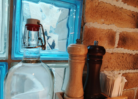 Salt and pepper shakers on a shelf in a restaurant kitchen.の写真素材