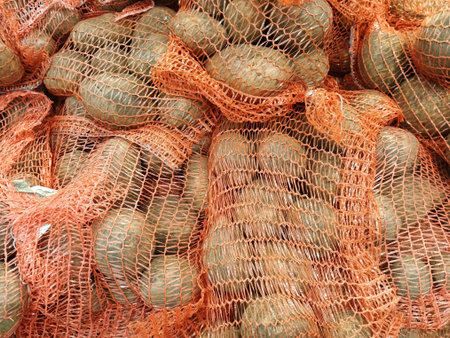 Potatoes in a net for sale at a market in India.